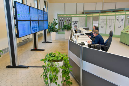 JST references - EnBW control centre: large display wall and operator desks. Side view.