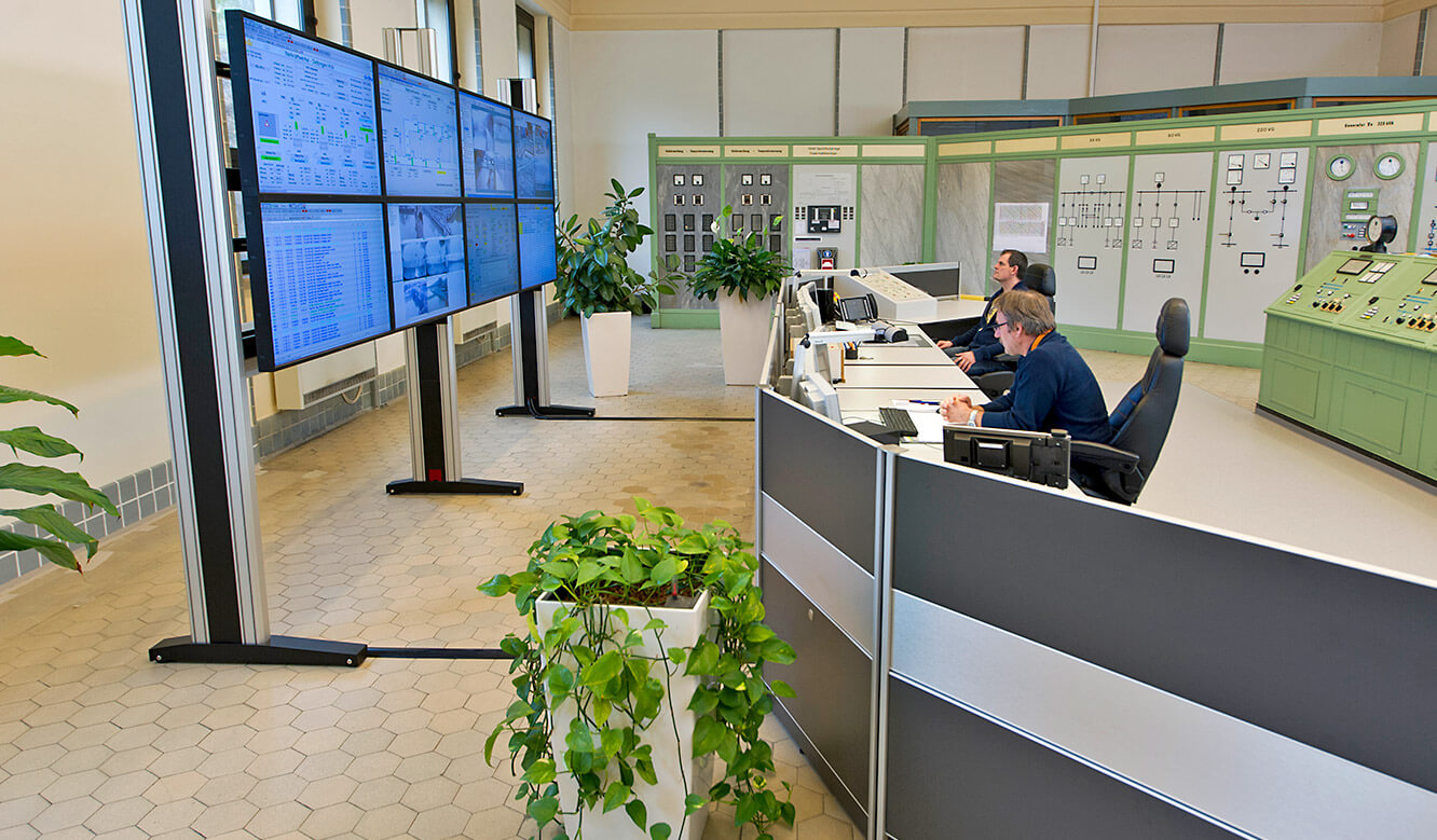 JST references - EnBW control centre: large display wall and operator desks. Side view.