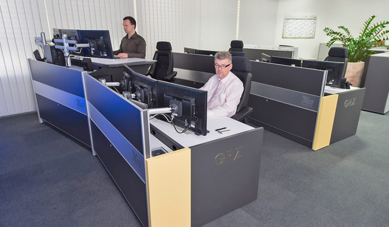 JST GRZ Linz desks are continuously height adjustable from sitting to standing height