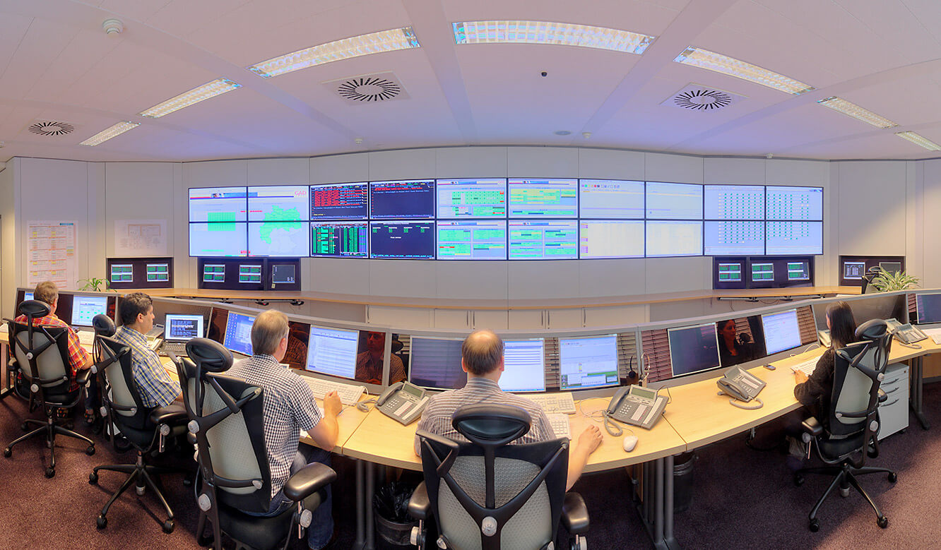 GAD - IT control centre of JST - Staff in front of the large display wall