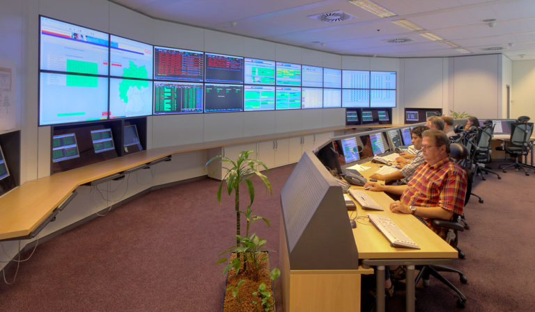 GAD - IT control centre of JST - Staff in front of the large display wall