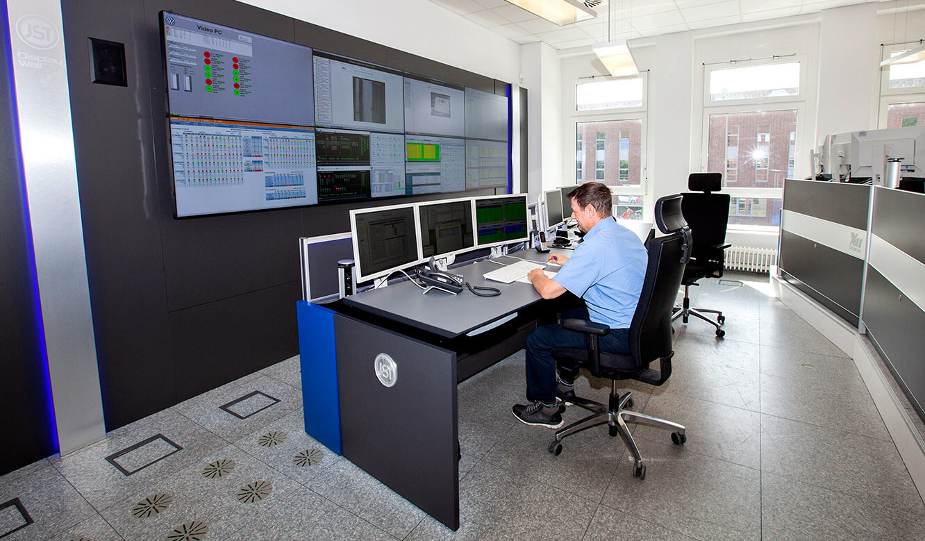 JST Volkswagen FIS control room: operator desk in front of the Videowall in sitting position