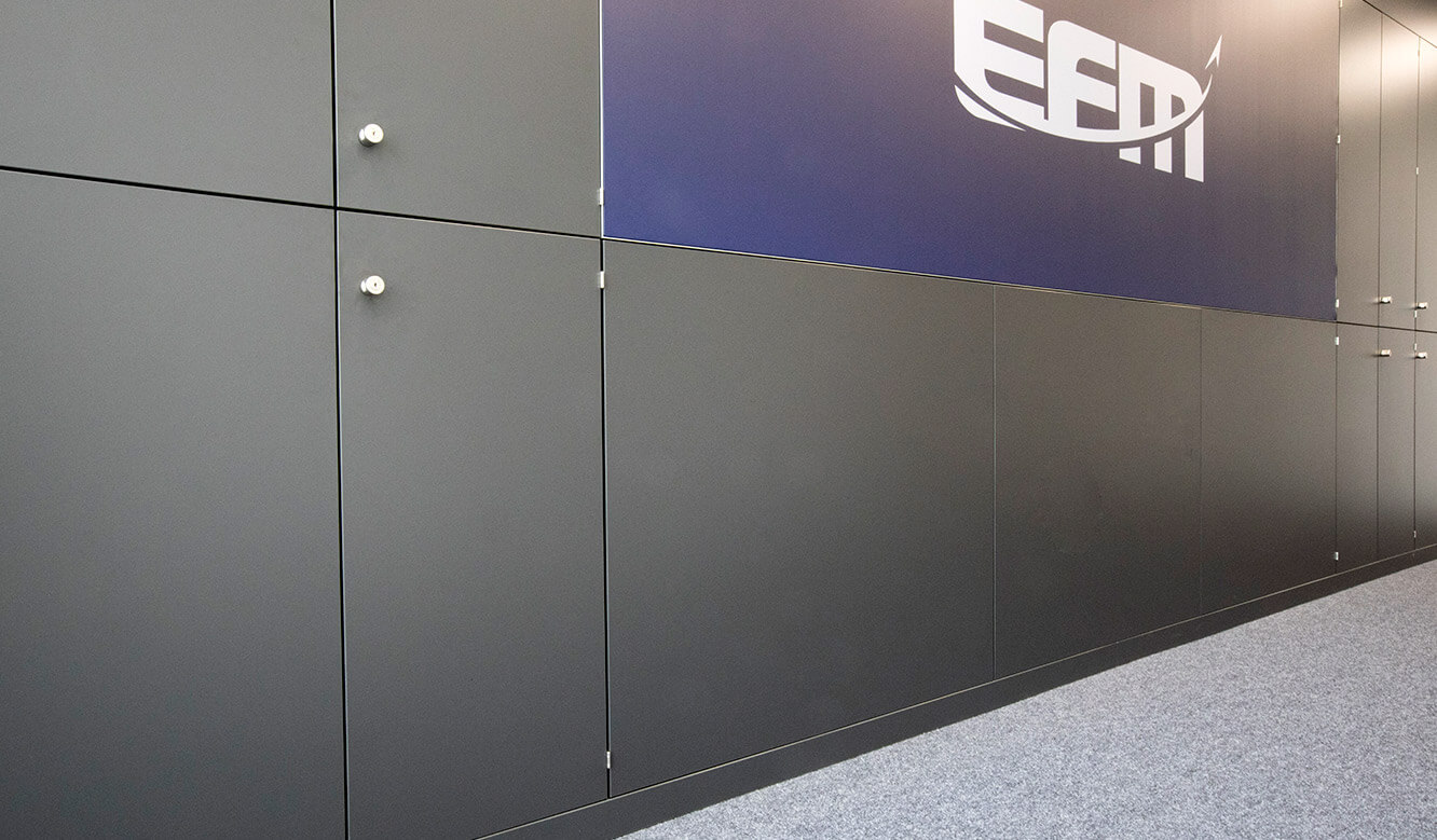 JST Reference Control Room EFM Munich Airport: Large screen wall integrated in room divider with cabinet solution