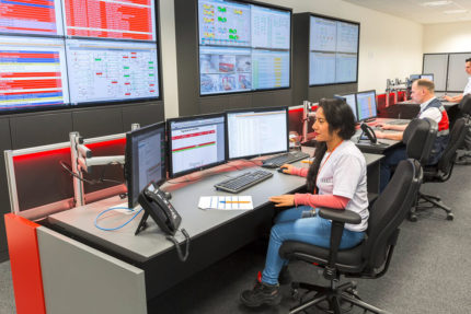 JST Audi Mexico: Operator in control room at control desk in front of display wall