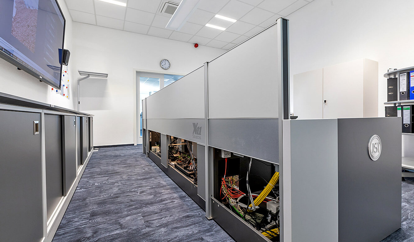 JST Control room energy supplier Städtische Werke Magdeburg: Control center desk with storage space for technology, illuminated